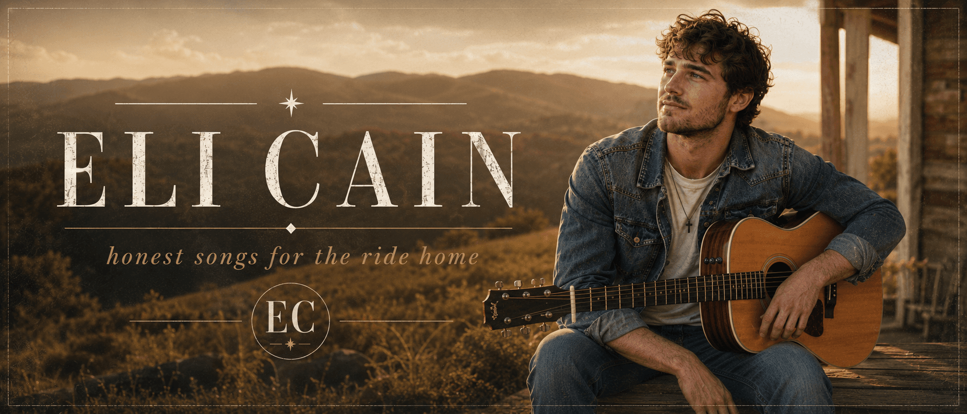 Eli Cain seated with an acoustic guitar overlooking the hills